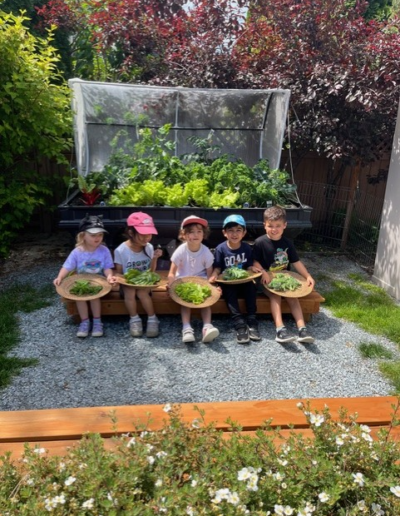 Coronation Montessori children with their garden produce