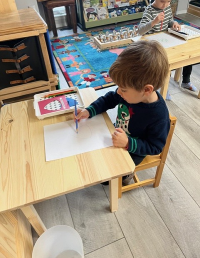 Coronation Montessori young boy at desk